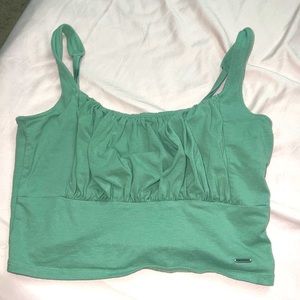 This top is an olive colored crop top from Hollister, only worn a few times .